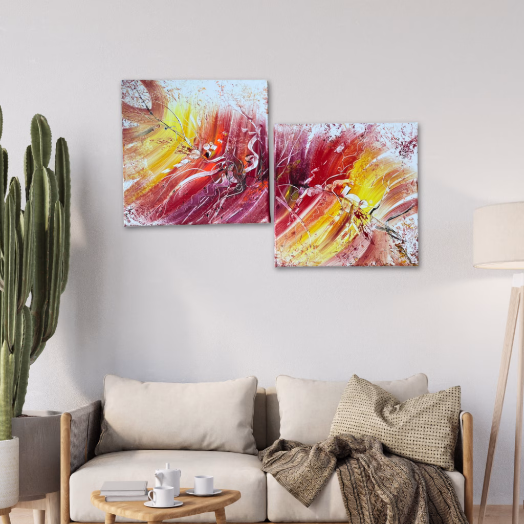 Online Kunstgalerie: Modernes Diptychon mit abstrakten, farbenfrohen Acrylbildern in Rot, Gelb und Weiß. Als Wandbild über einem beigen Sofa im Wohnzimmer.